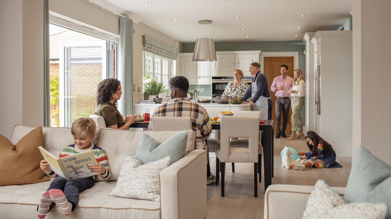 Redrow | Inspiration | A young couple opening the patio doors to let their children play