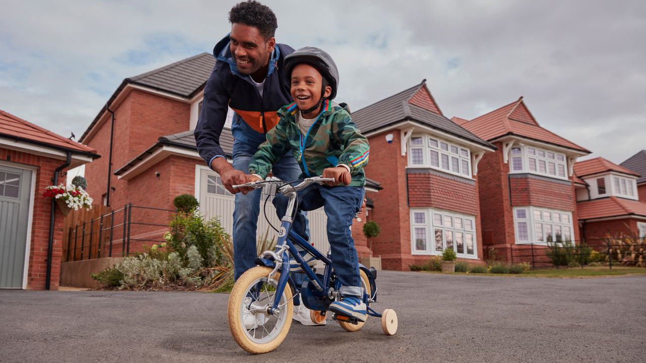 Redrow - Inspiration - Father teaches son to ride a bike
