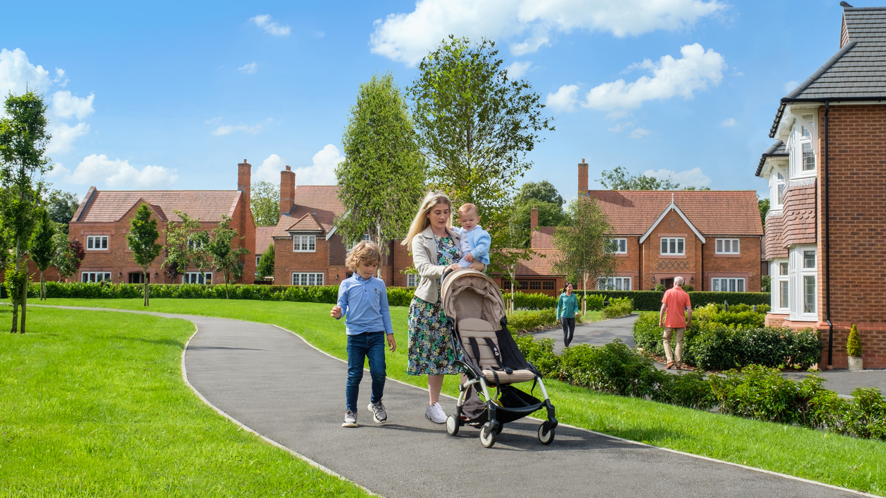 Redrow - Inspiration - Mother with pram and 2 children walking through a Redrow development